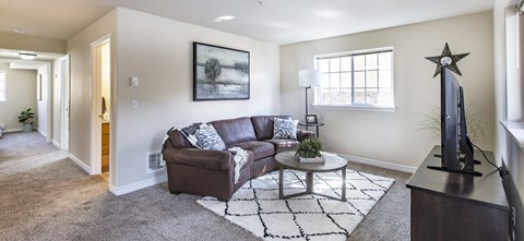 a living room with a couch and a coffee table  at Quail Springs, Washington