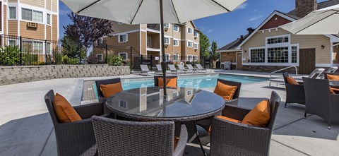 our apartments have a pool and patio with chairs and umbrellas  at Quail Springs, Washington, 99353
