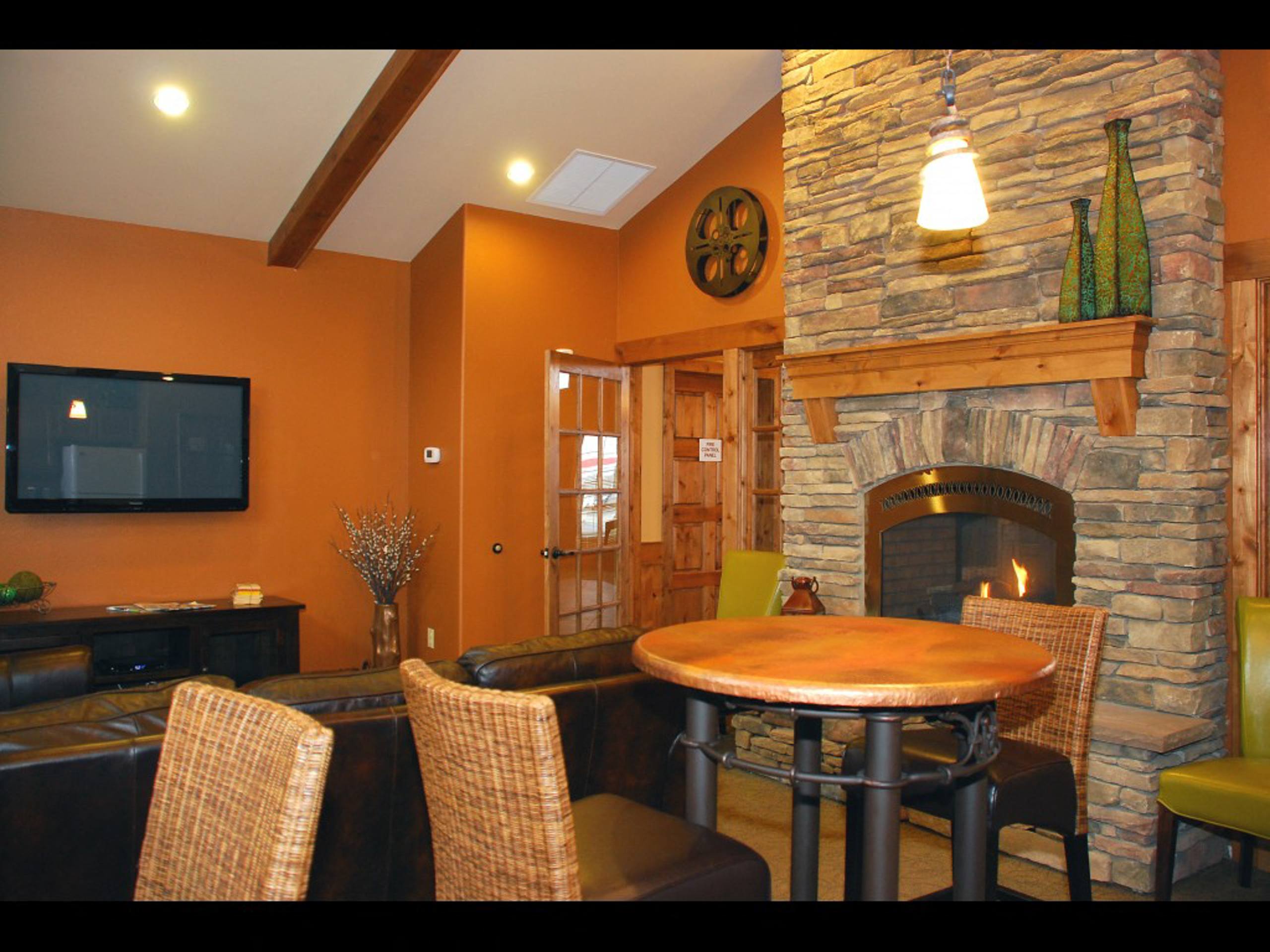 a living room with a table and a fireplace  at Quail Springs, West Richland, WA, 99353