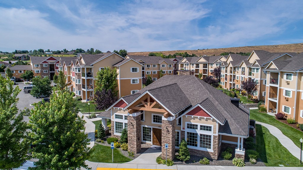 an aerial view of an apartment complex with trees and buildings at Quail Springs, West Richland, WA