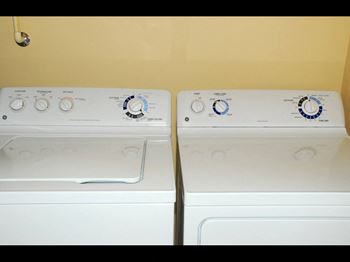two washes and dryers in the laundry room