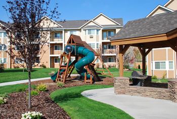 a playground in front of an apartment building