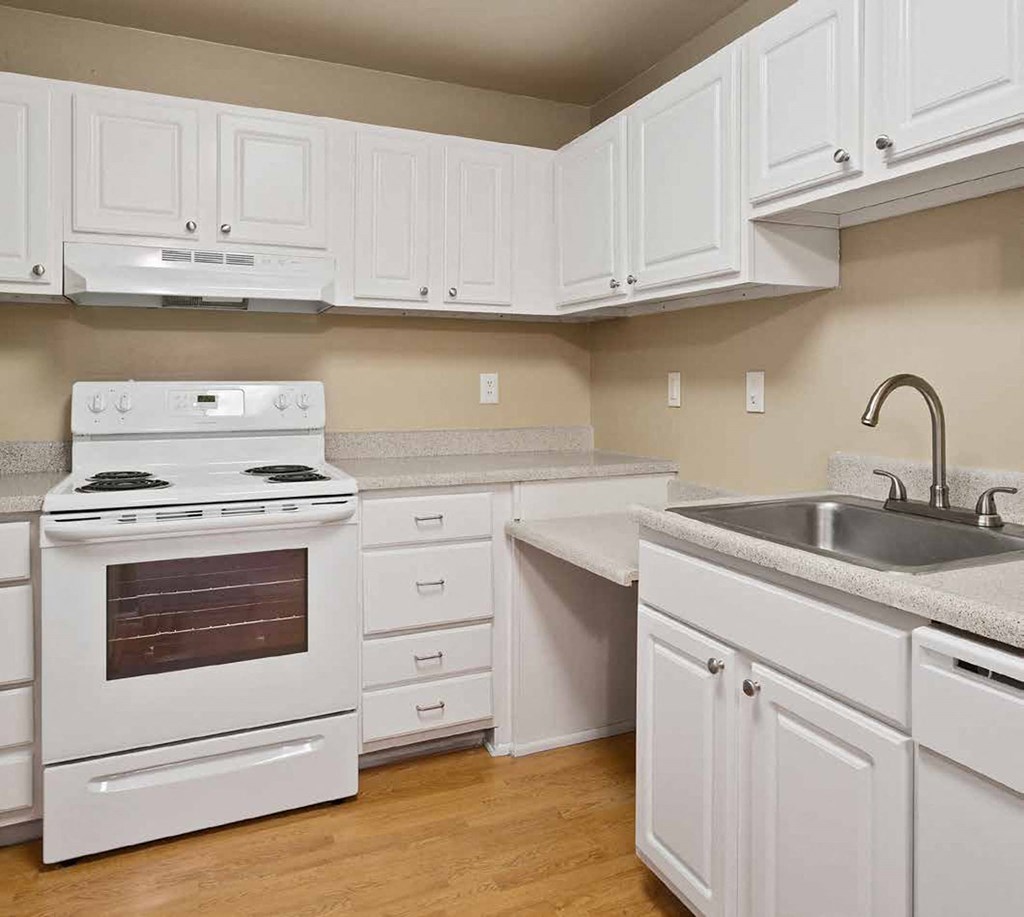 a kitchen with white cabinets and a stove and a sink at Quartz Creek, Washington, 98043