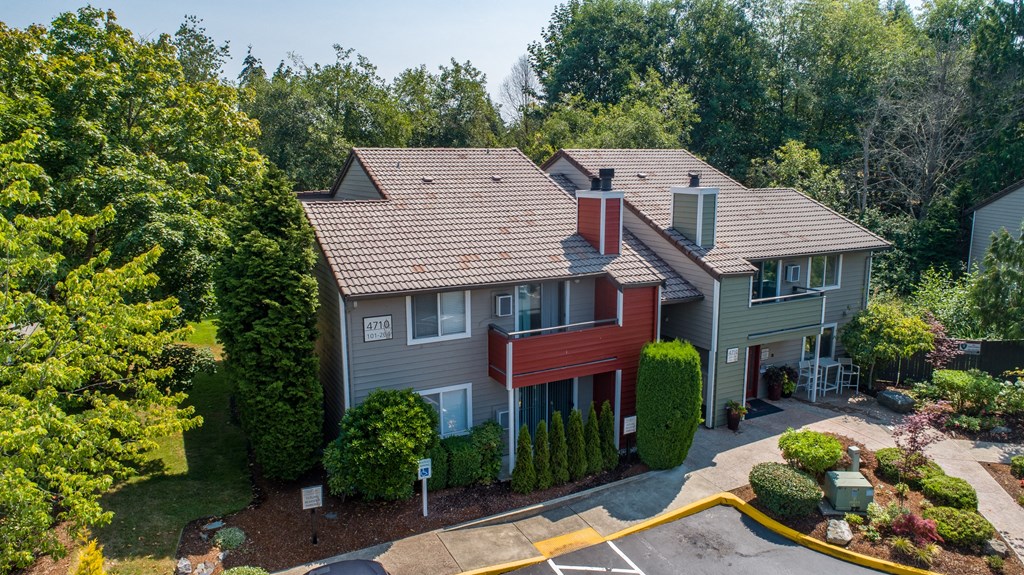 an aerial view of a home with a red and gray house and trees at Quartz Creek, Washington