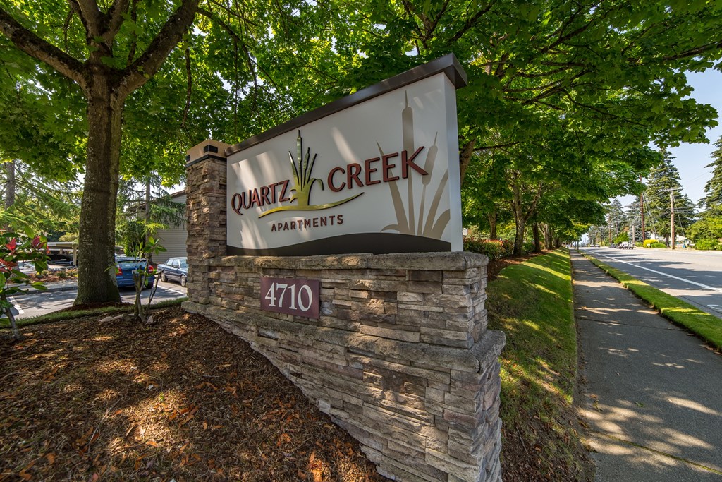 a sign for center creek apartments on the side of a road at Quartz Creek, Washington