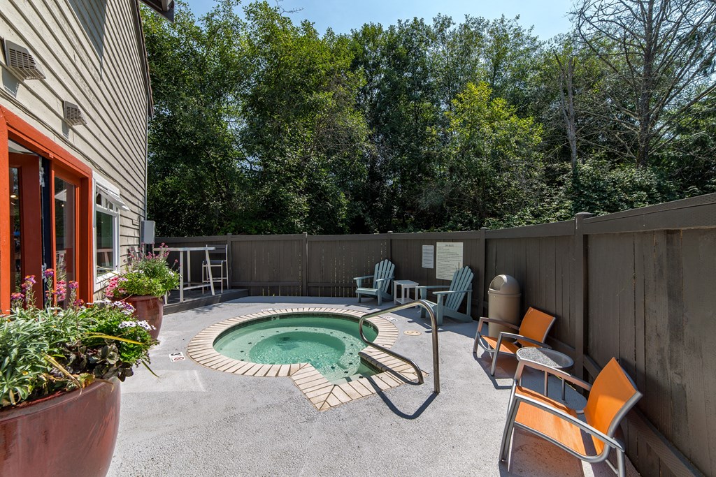 a backyard with a pool and patio with chairs and a table at Quartz Creek, Washington, 98043