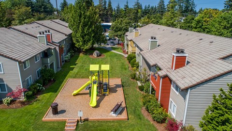 an aerial view of a yellow swing set in the backyard of a house at Quartz Creek, Washington