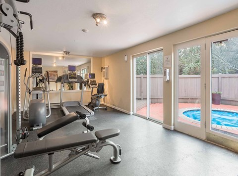 a gym with weights and a pool in the corner at Quartz Creek, Washington