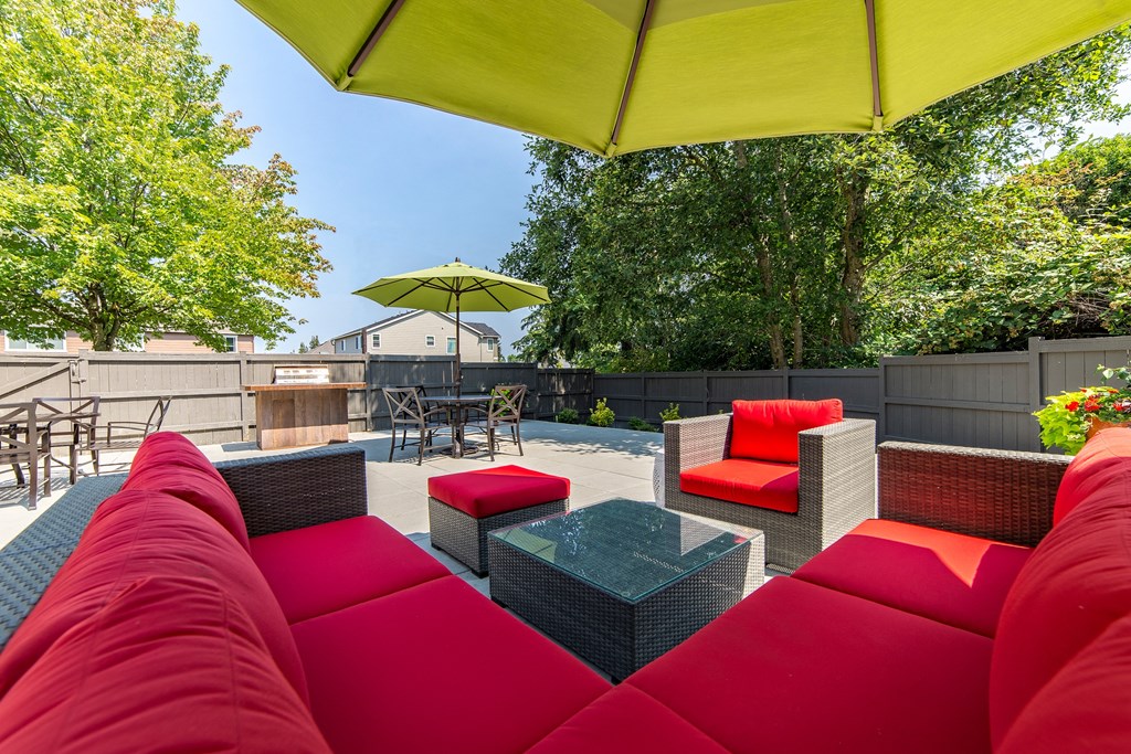 a patio with couches and chairs and a table at Quartz Creek, Mountlake Terrace
