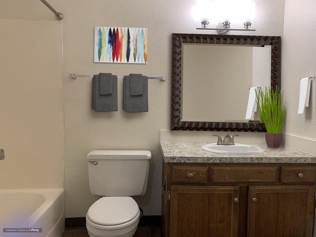 a bathroom with a toilet sink and a mirror  at Rock Creek, Billings, MT 59102