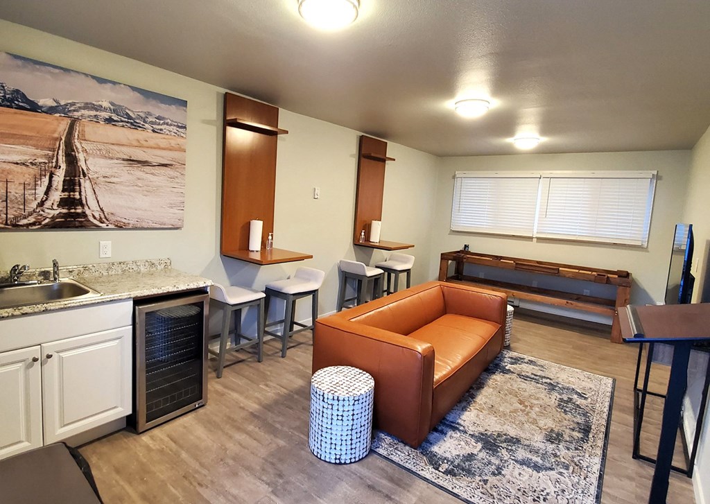 a living room with a couch and a kitchen with a sink and a counter top at Rock Creek, Billings Montana