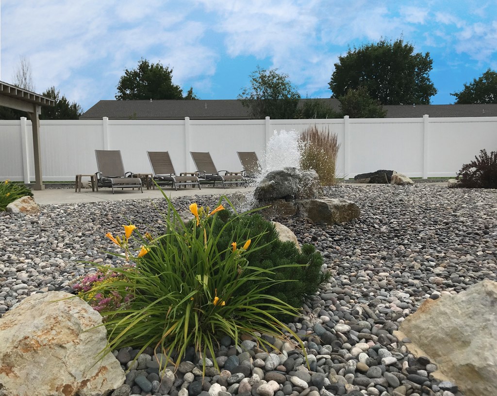 a water feature in a rock garden with rocks and plants at Rock Creek, Billings, MT