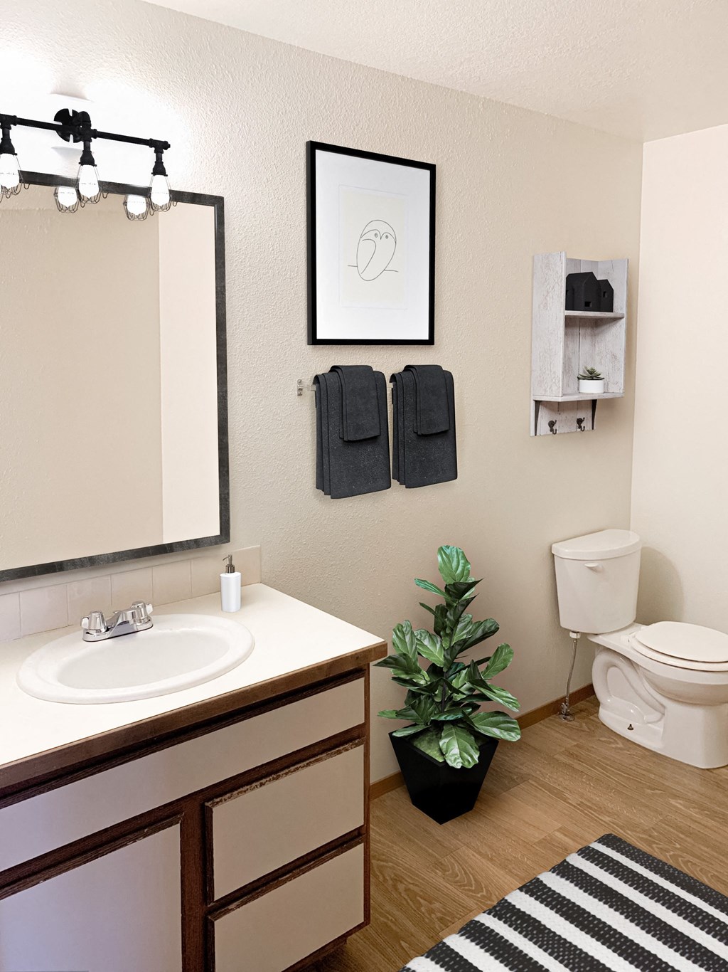 a bathroom with a toilet sink and mirror and a plant at Shiloh Glen, Montana, 59102