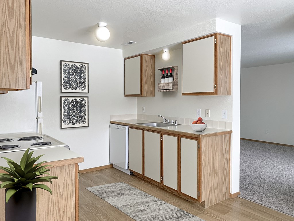 our apartments offer a kitchen with white appliances and wood cabinets at Shiloh Glen, Billings, MT 59102