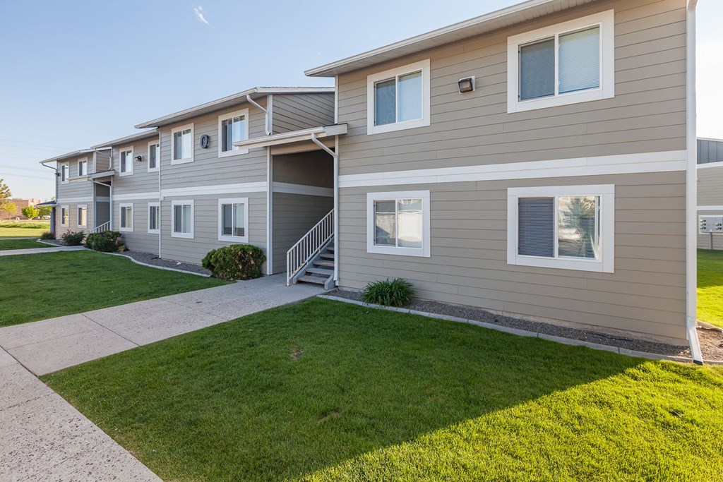 a sidewalk in front of a building with grass at Shiloh Glen, Billings Montana