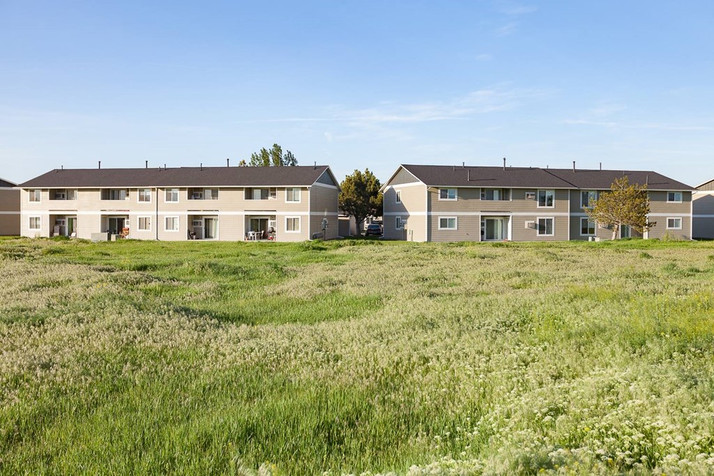 a row of apartment buildings in a field at Shiloh Glen, Billings