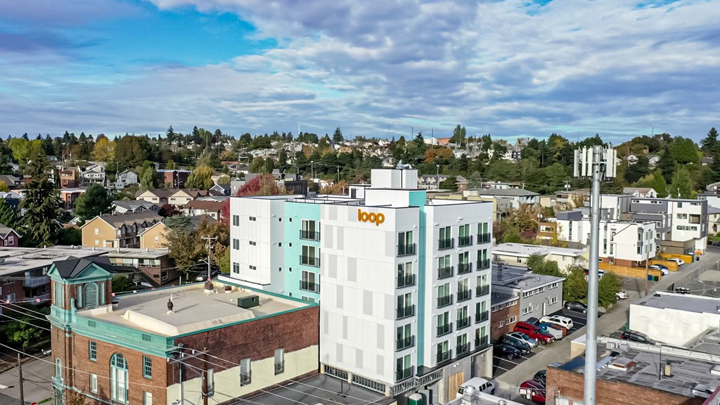 an aerial view of a white building with a yellow hp logo on it at The Loop at Green Lake, Washington