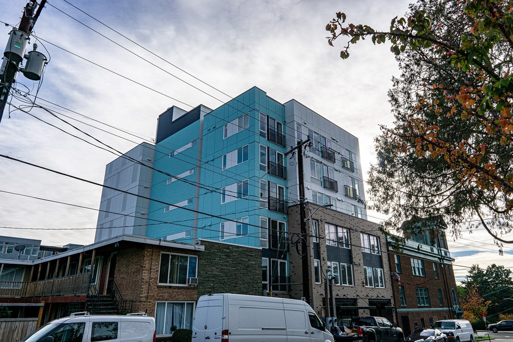 a new building on a city street with parked cars at The Loop at Green Lake, Seattle, Washington