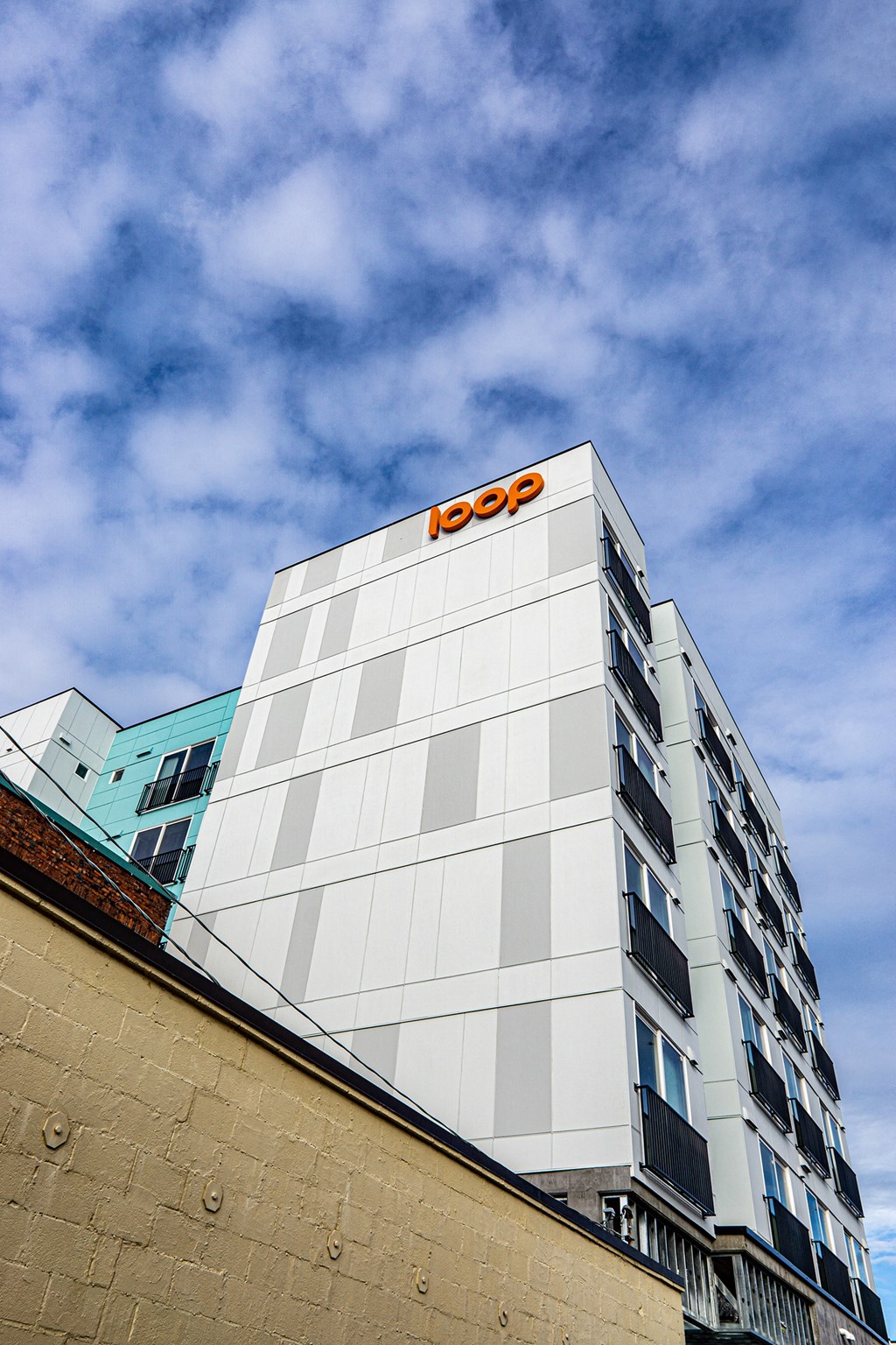 the top of a building with the logo on top of it at The Loop at Green Lake, Washington, 98115