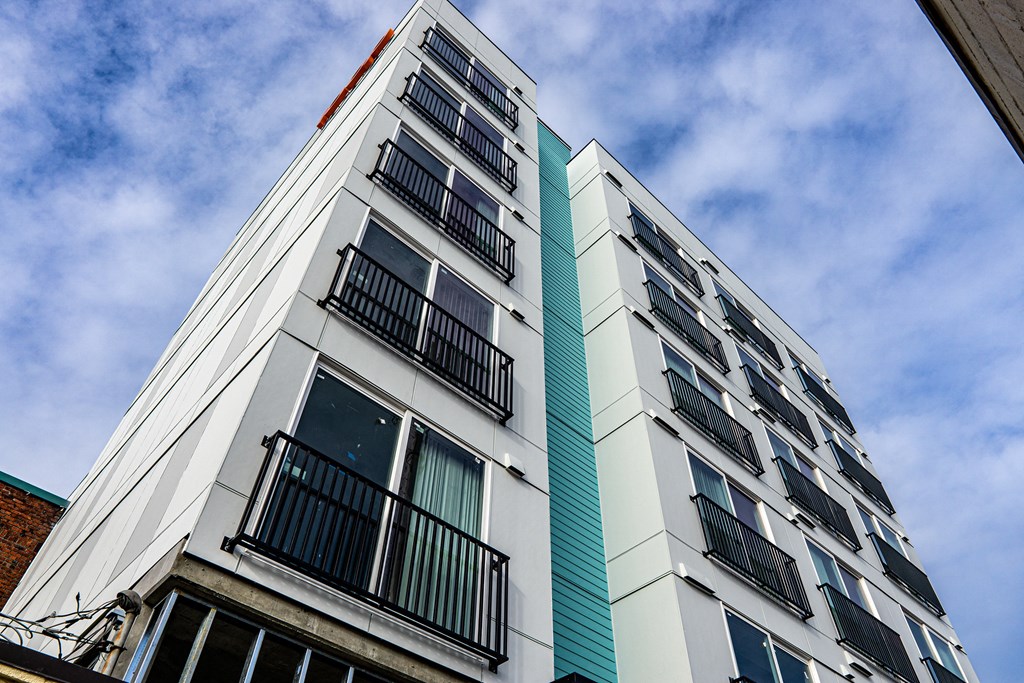 a tall apartment building with balconies and a blue and white facade at The Loop at Green Lake, Washington, 98115