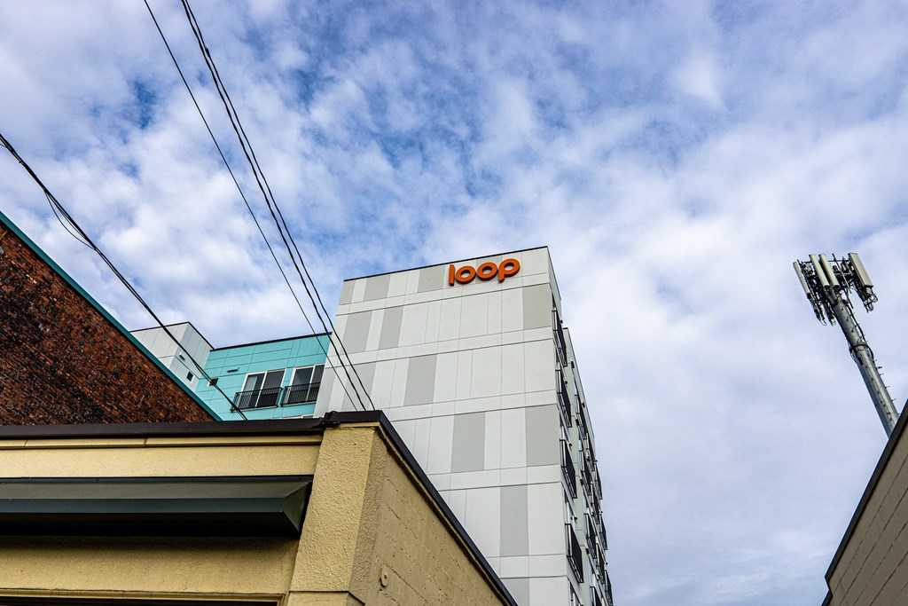 a building with the logo on top of it at The Loop at Green Lake, Seattle, 98115