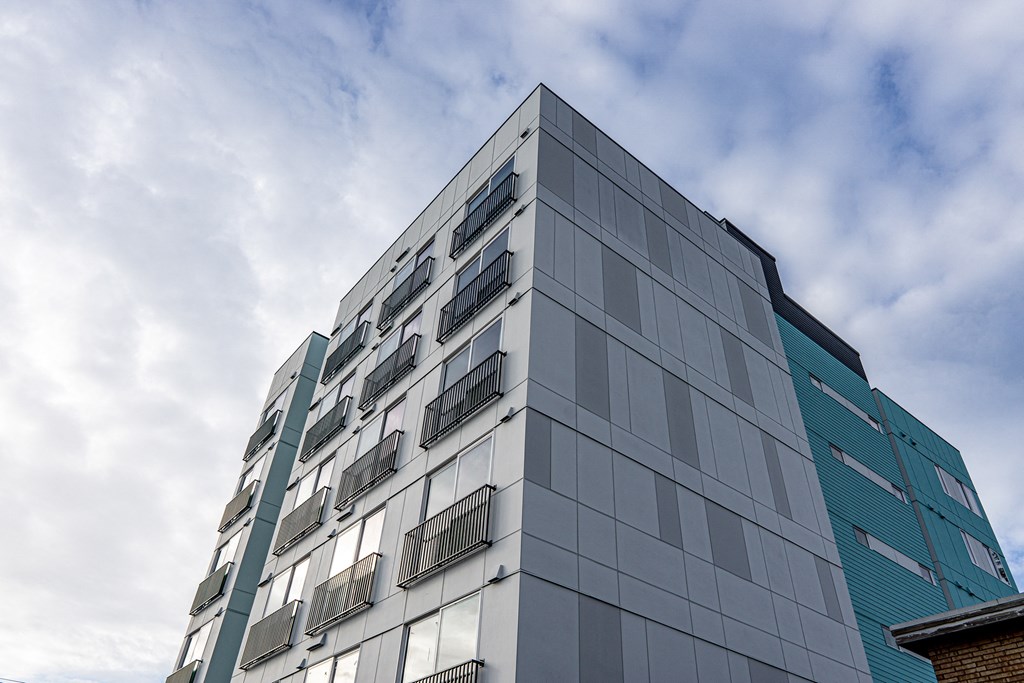 the side of a building with a cloudy sky in the background at The Loop at Green Lake, Washington, 98115