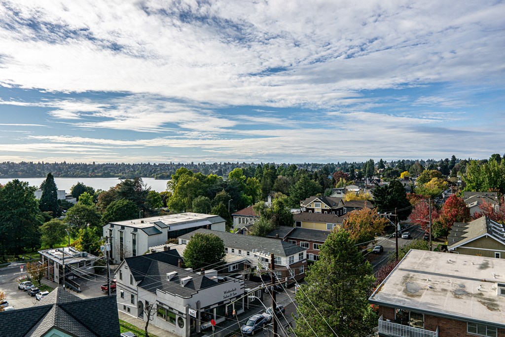 an aerial view of a city with a lake and buildings at The Loop at Green Lake, Seattle, Washington