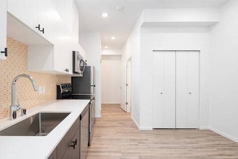 a renovated kitchen with white cabinets and a sink at The Loop at Green Lake, Seattle, WA, 98115