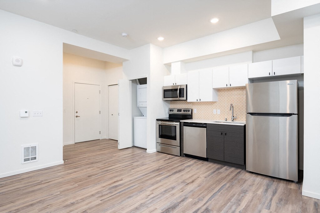 a kitchen with stainless steel appliances and white cabinets at The Loop at Green Lake, Washington