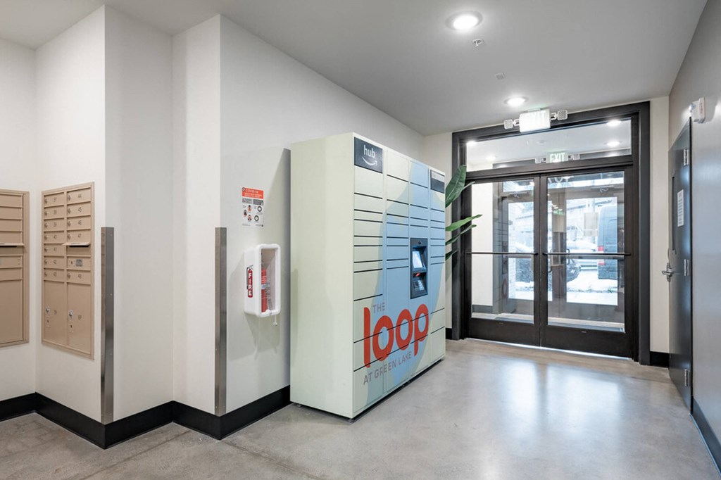 a room with a refrigerator and a glass door at The Loop at Green Lake, Seattle, WA, 98115