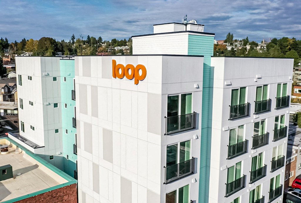 the top of a building with the logo on it at The Loop at Green Lake, Seattle, WA