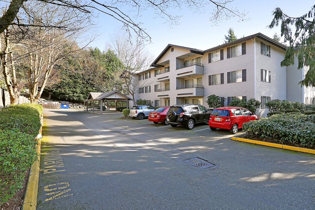 a large apartment building with cars parked in front of it  at Townside Flats, Redmond, Washington