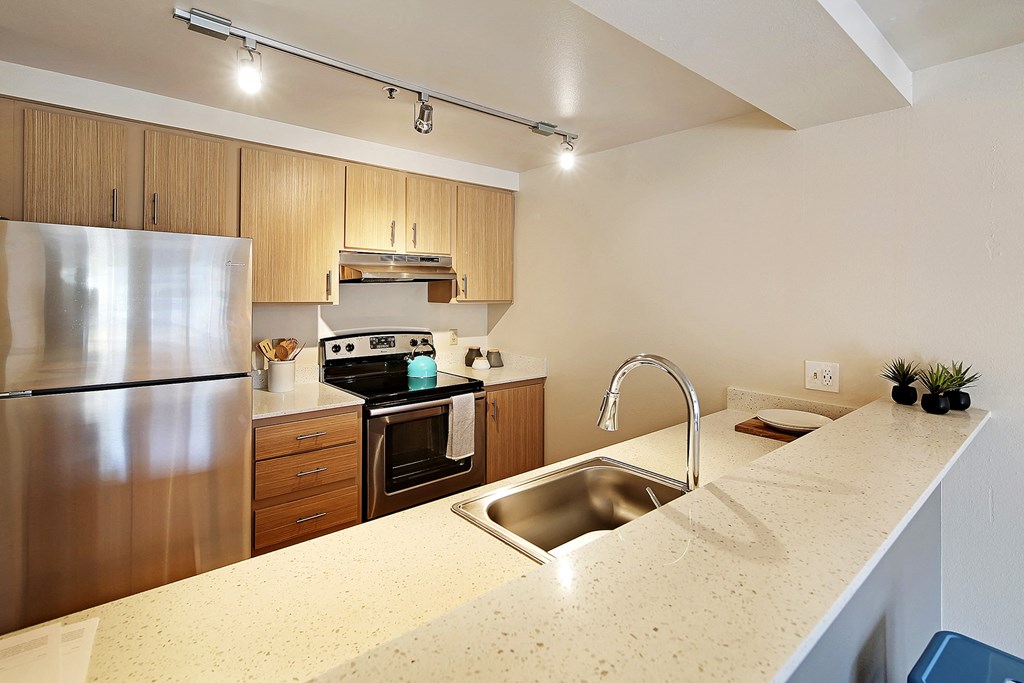 a kitchen with stainless steel appliances and a granite counter top  at Townside Flats, Redmond, Washington