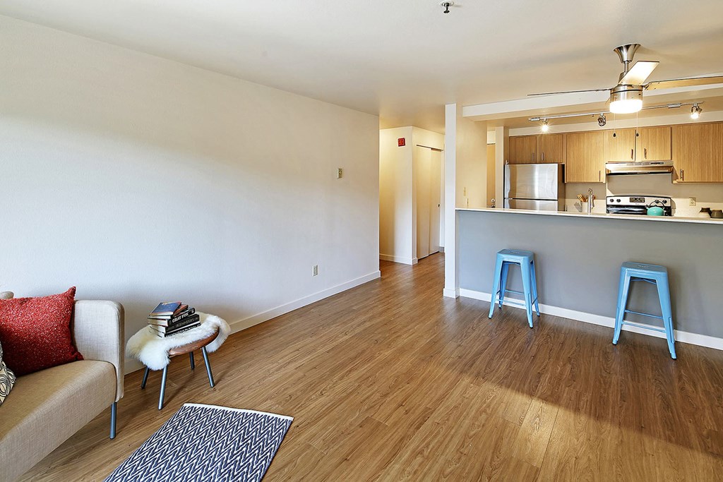 a living room and kitchen with blue stools  at Townside Flats, Washington