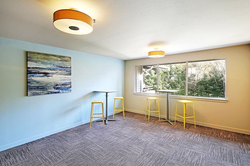 an empty room with bar stools and a window  at Townside Flats, Redmond