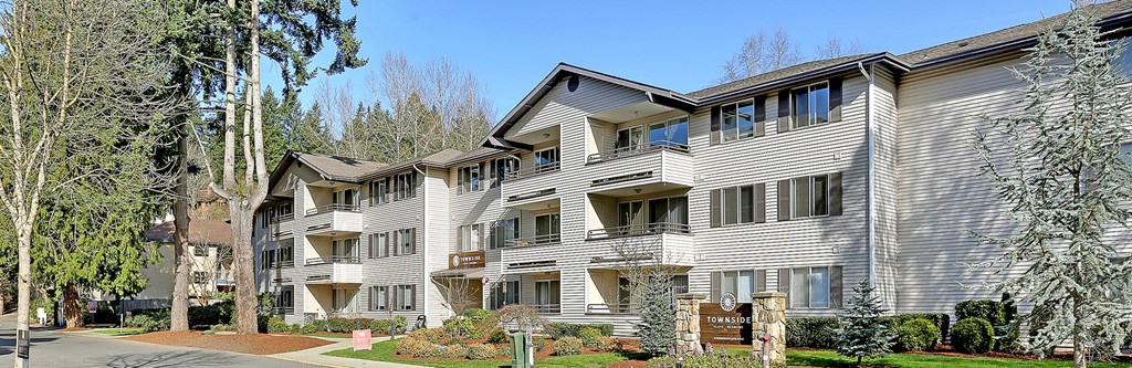 a large condo building with a street in front of it  at Townside Flats, Redmond, Washington