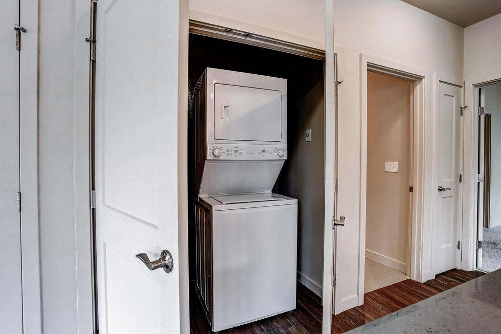 a small closet with a refrigerator and a washing machine in it at Woodcreek, Washington