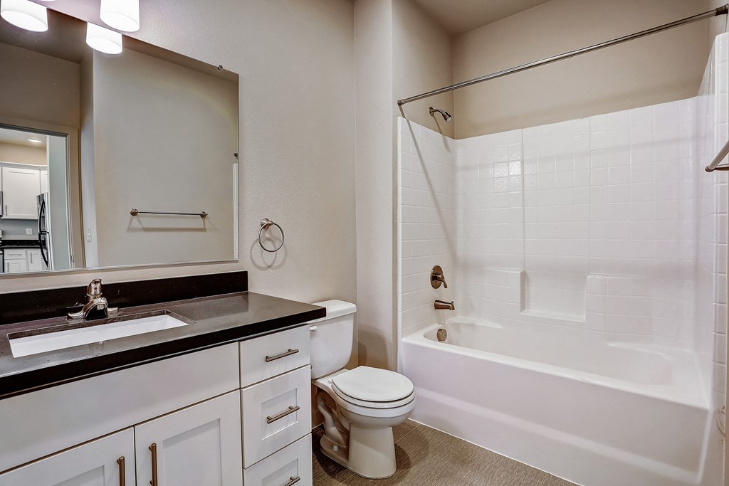 a bathroom with a toilet and a tub and a sink at Woodcreek, Washington, 98370