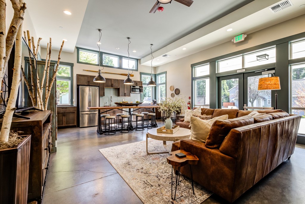 a large living room with a leather couch and a table at Woodcreek, Washington, 98370