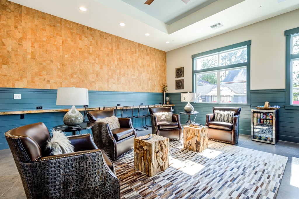 a living room with chairs and tables and a large window at Woodcreek, Poulsbo Washington