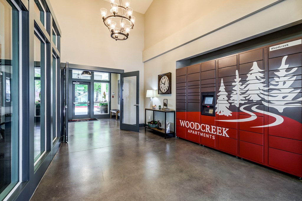 the lobby apartments with a reception desk and a wood creek partners sign at Woodcreek, Poulsbo, 98370