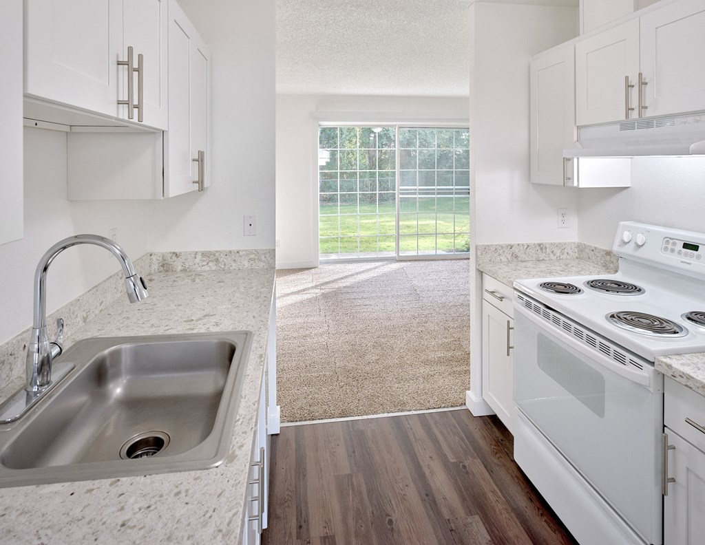 a kitchen with a sink and a stove and a window at Woodcreek, Poulsbo, WA 98370