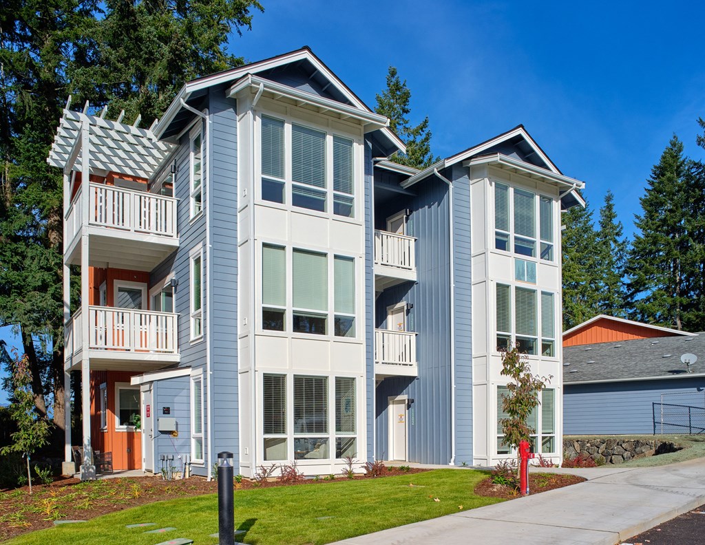 a blue and white house with a sidewalk in front of it at Woodcreek, Poulsbo, 98370