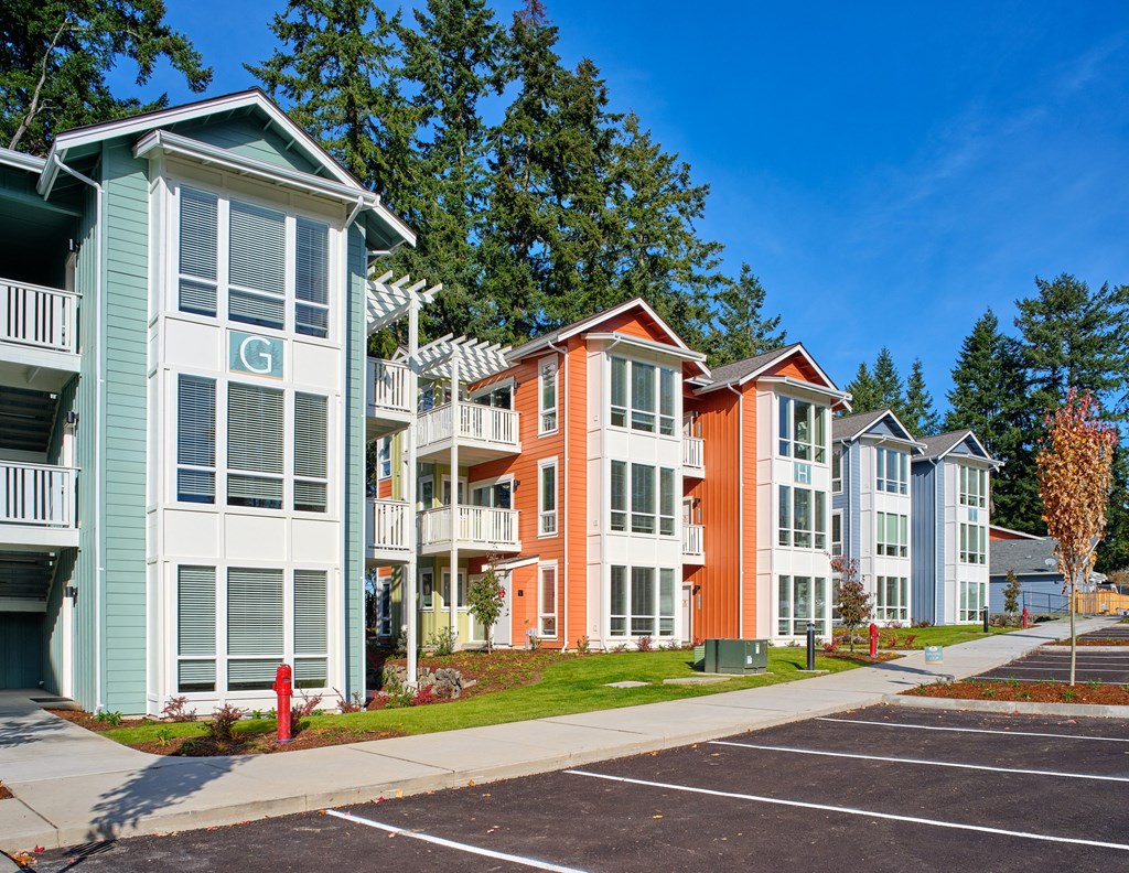 a row of colorful town houses on a sidewalk at Woodcreek, Poulsbo, WA