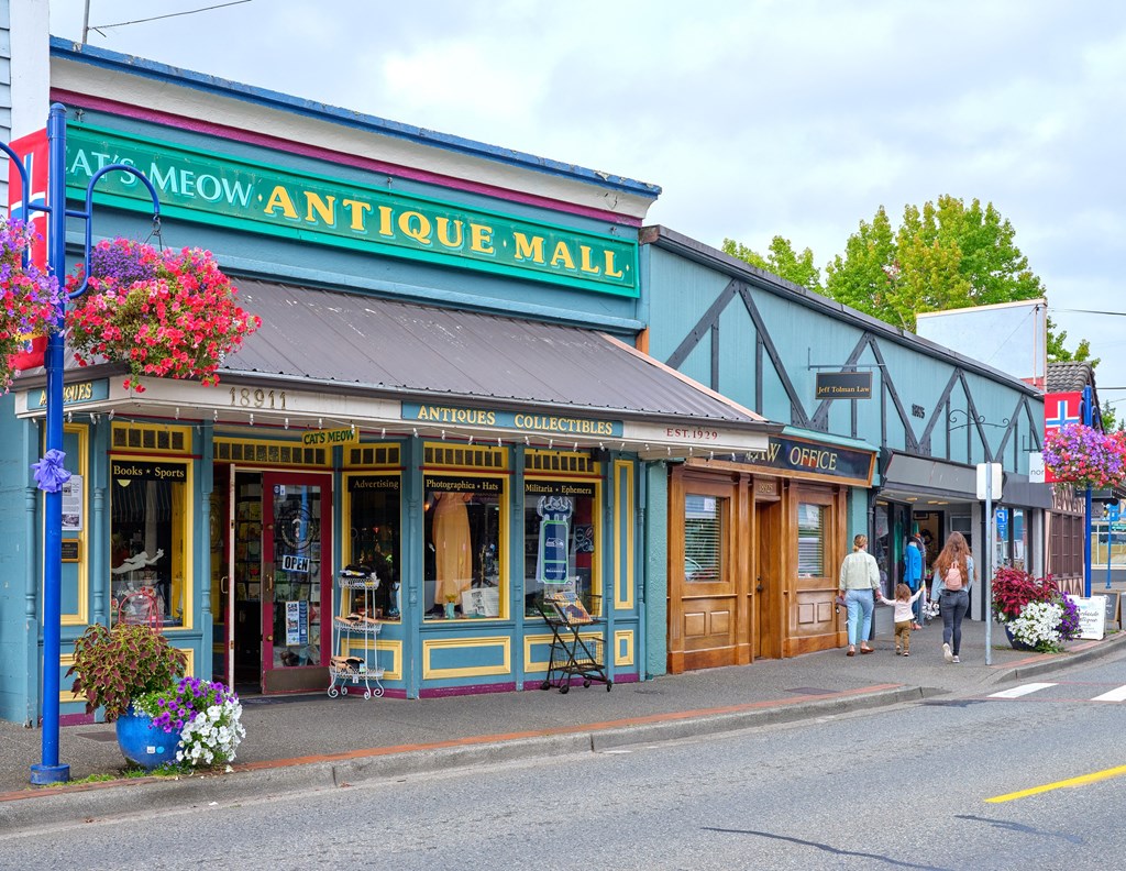 people walking down a street in front of an antique mall at Woodcreek, Poulsbo, WA 98370