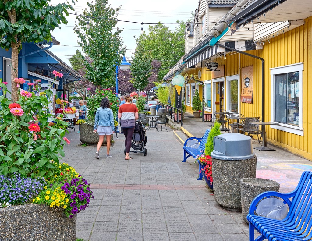 a couple of people walking down a sidewalk with a stroller at Woodcreek, Washington