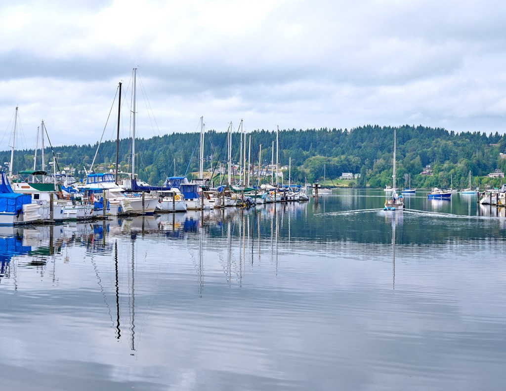 a marina filled with boats on a lake at Woodcreek, Poulsbo