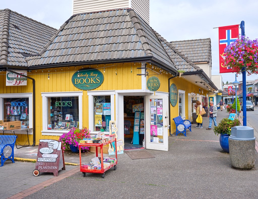 a yellow store with books on the side of a street at Woodcreek, Washington, 98370