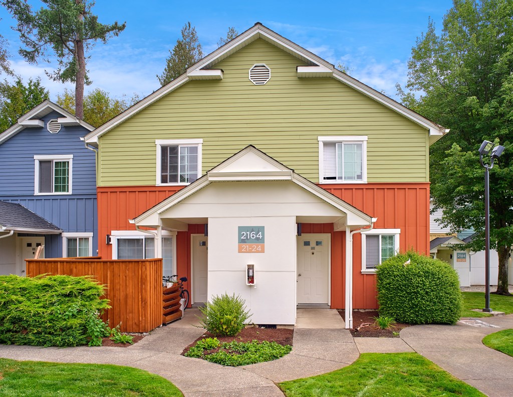 the front of a house with a porch and a sidewalk at Woodcreek, Poulsbo Washington 