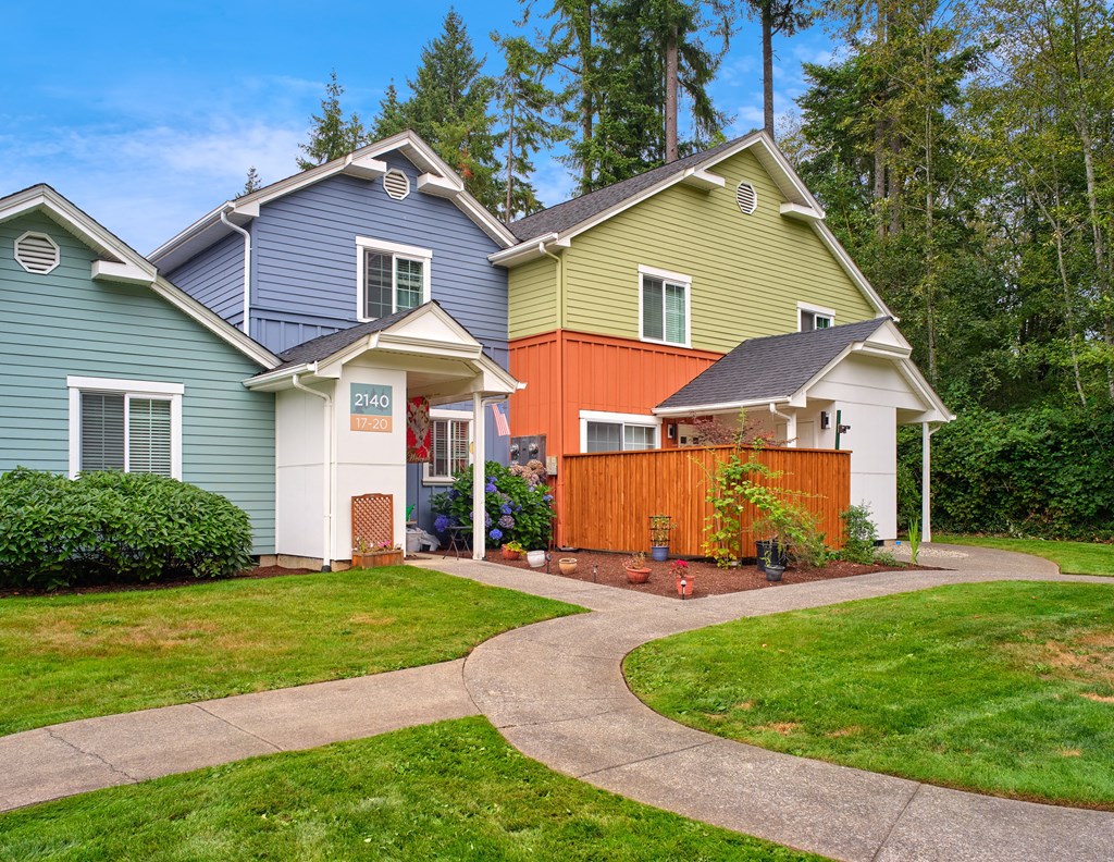 a group of houses with a sidewalk in front of a yard at Woodcreek, Poulsbo, WA 98370